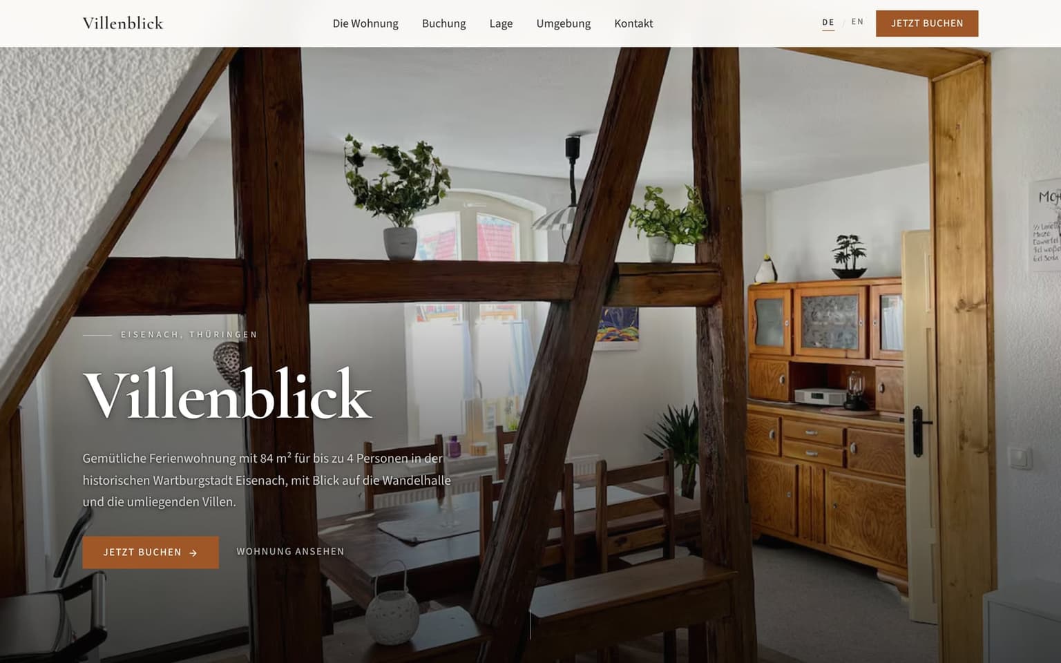 Villenblick start page: a photo of the timber-framed living room, with copper booking buttons